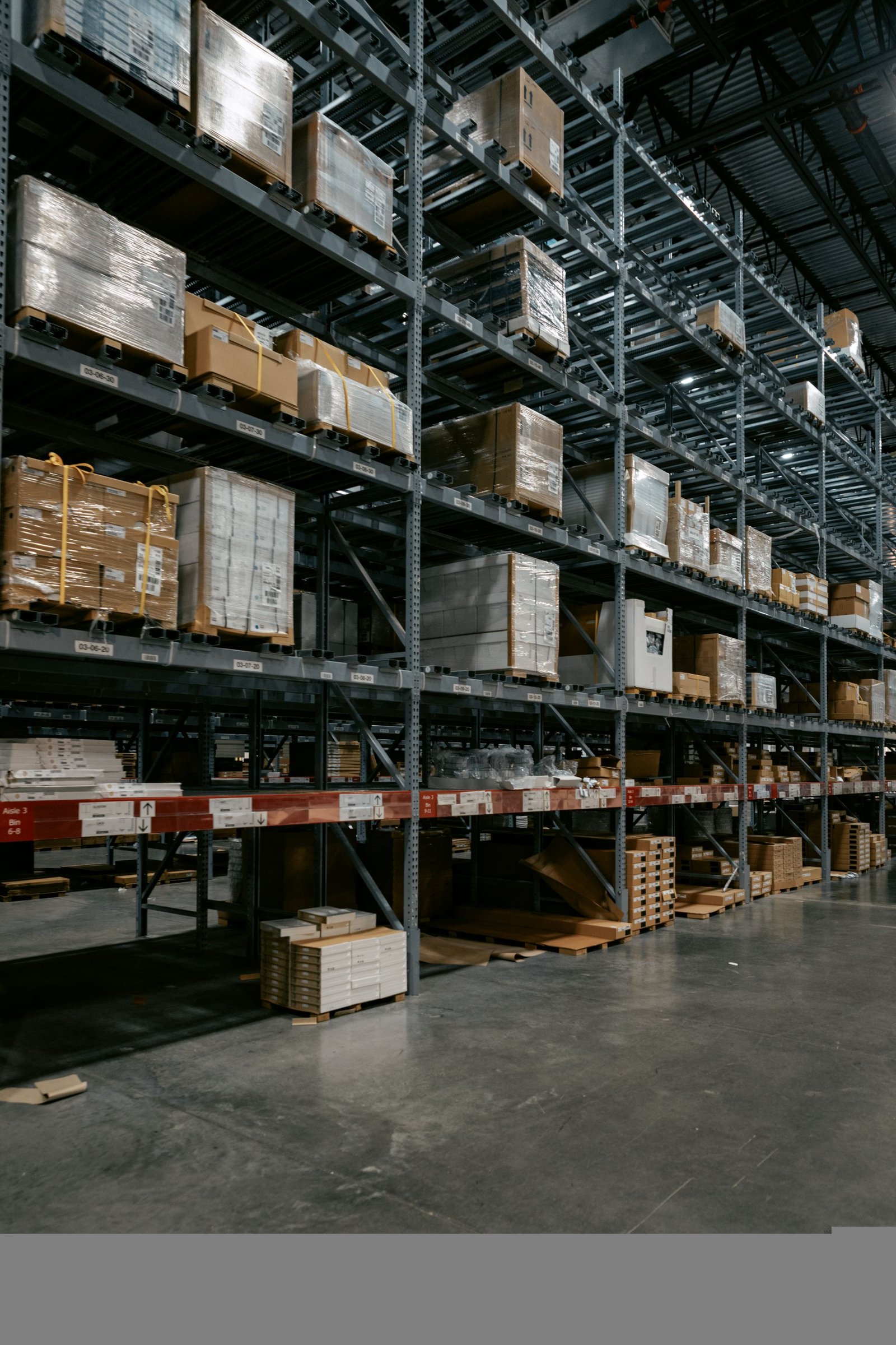 Wrapped pallets and cartons distributed across tall industrial racks